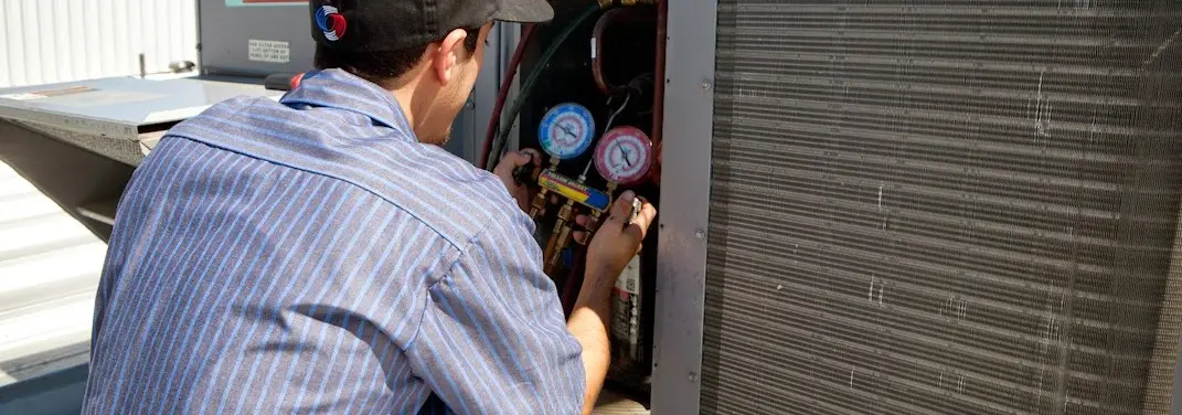 HVAC technician servicing a condenser unit in Ocala